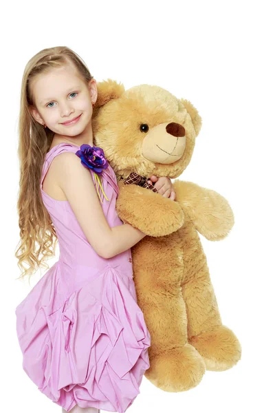 Beautiful little girl 5-6 years.She is holding a large teddy bea — Stock Photo, Image