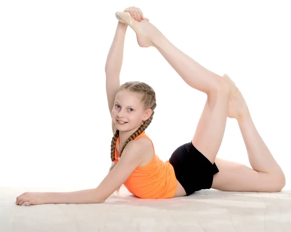 La gimnasta realiza un elemento acrobático en el suelo . — Foto de Stock