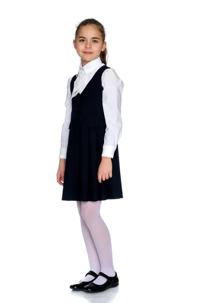 Beautiful little girl in a school uniform. — Stock Photo, Image