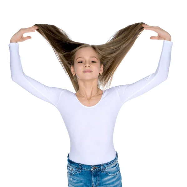 A little girl fixes her hair. — Stock Photo, Image