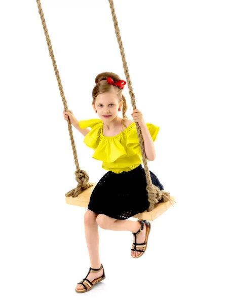 Joyful little girl swinging on a swing. — Stock Photo, Image