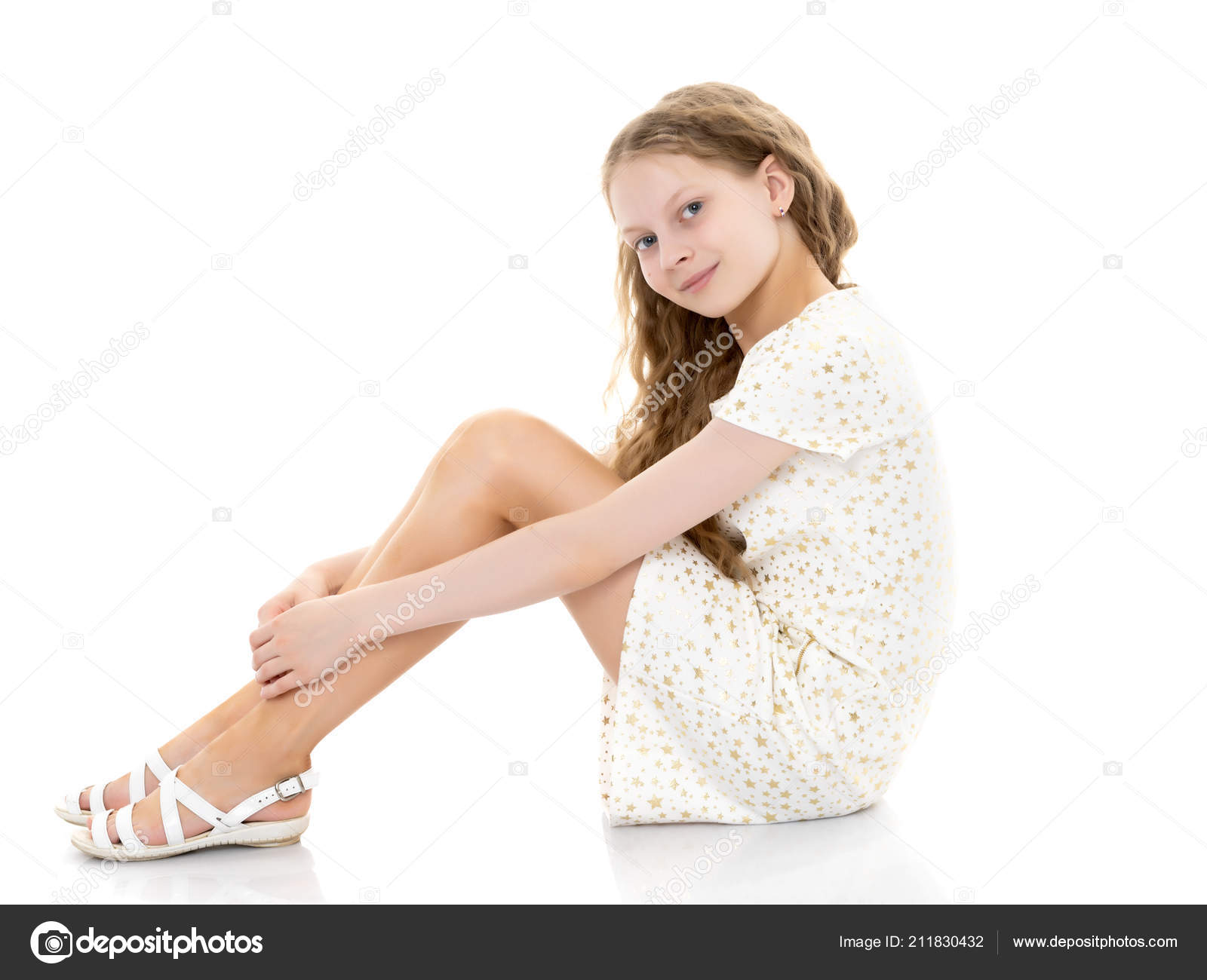 Download - A teenage girl in a short dress sits on the floor and holds ...