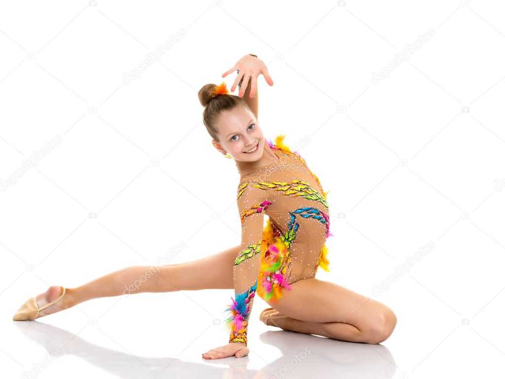 The gymnast perform an acrobatic element on the floor.