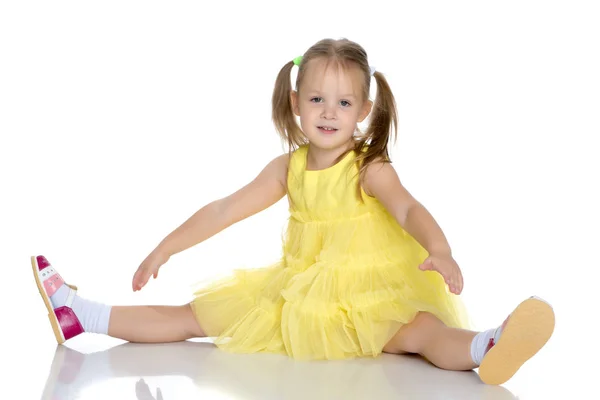 Little girl is sitting on the floor. — Stock Photo, Image