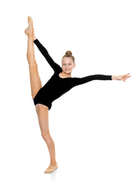 The gymnast balances on one leg. — Stock Photo, Image