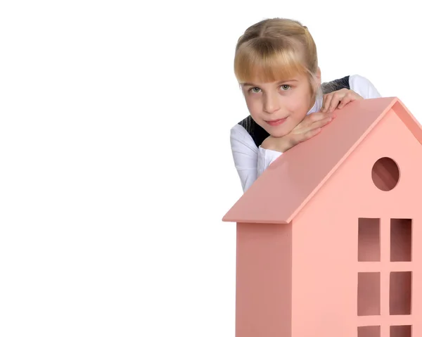 Little girl is playing with wooden houses. — Stock Photo, Image