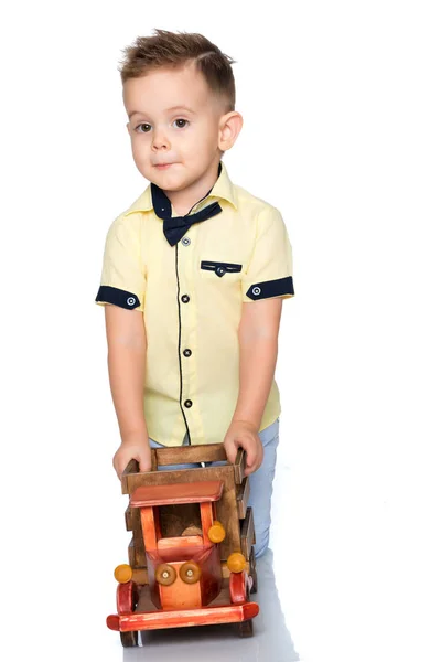 A little boy is playing with a toy car. — Stock Photo, Image