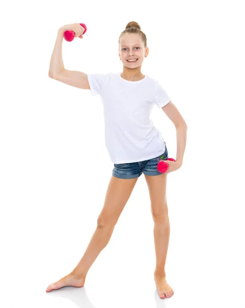 Little girl doing exercises with dumbbells. — Stock Photo, Image