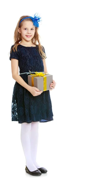 Cute little girl with a gift in hand. — Stock Photo, Image