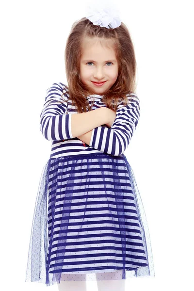 Cute little girl posing in front of the camera. Stock Picture