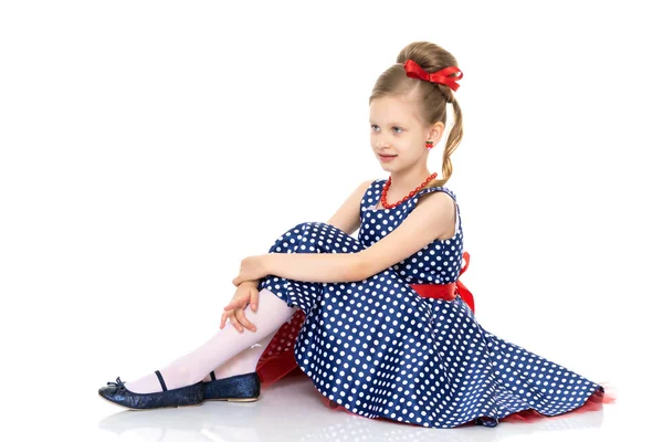 Little girl is sitting on the floor. Royalty Free Stock Photos