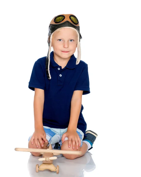 Little boy with a wooden plane. — Stock Photo, Image