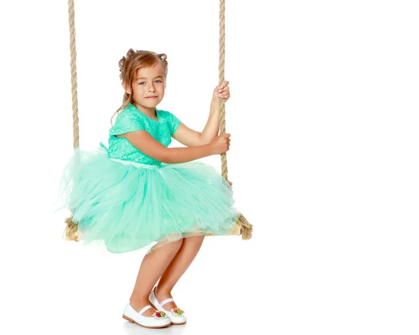 Little girl swinging on a swing — Stock Photo, Image