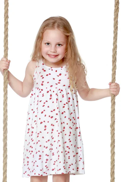 Little girl swinging on a swing — Stock Photo, Image