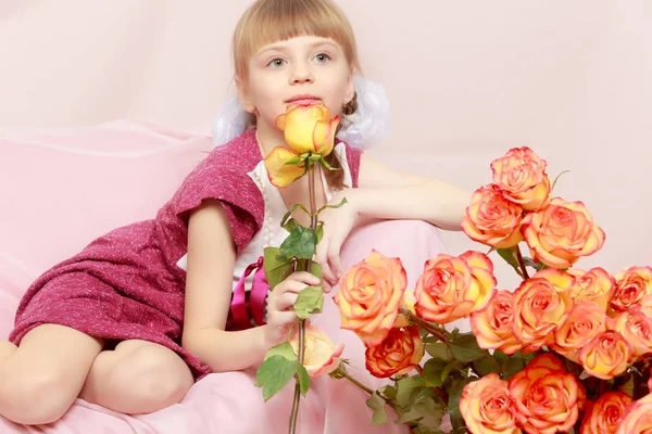 Kleines Mädchen mit einem Strauß Teerosen. — Stockfoto