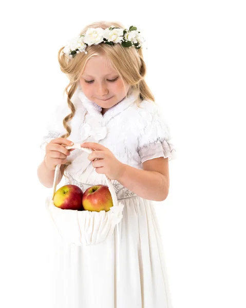 Little girl with a basket of apples. — Stock Photo, Image
