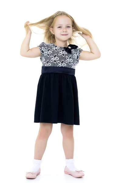 A little girl fixes her hair. — Stock Photo, Image