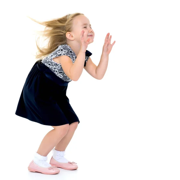 Little girl in a dress developing in the wind. — Stock Photo, Image