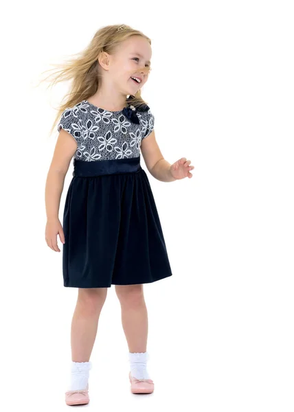 Little girl in a dress developing in the wind. — Stock Photo, Image