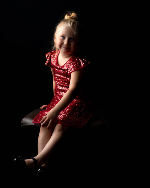 Little girl on a black background