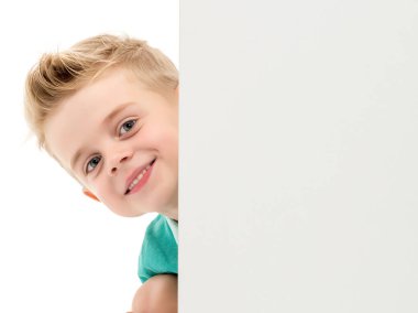 Küçük bir çocuk arkasından boş bir afiş arıyor.