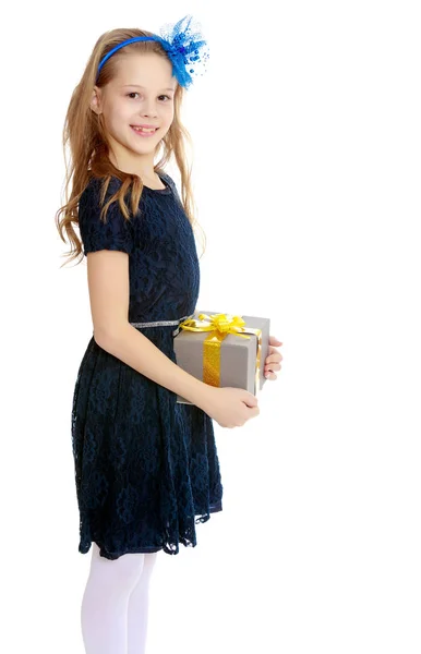 Cute little girl with a gift in hand. — Stock Photo, Image