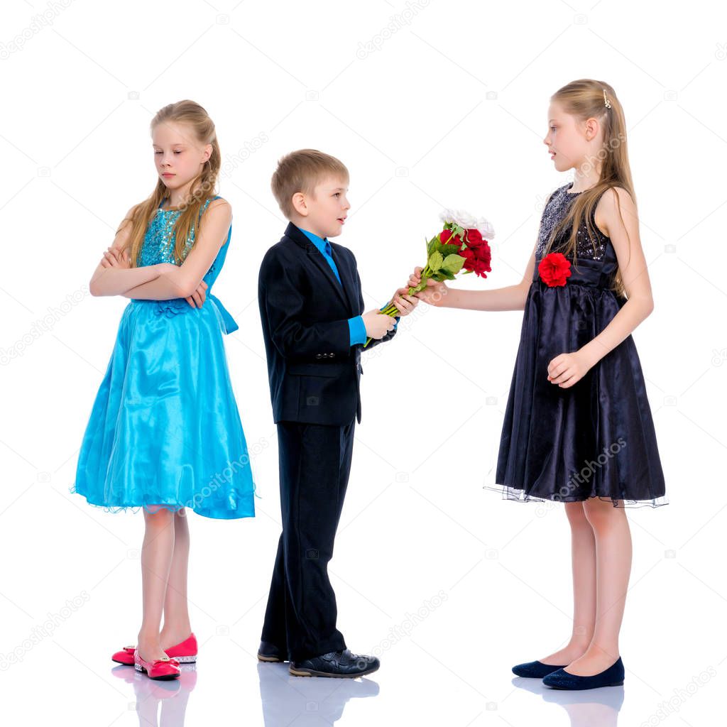 A little boy gives the girl flowers.