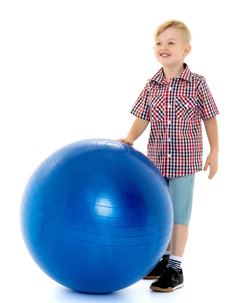 A little boy is playing with a ball. Stock Image