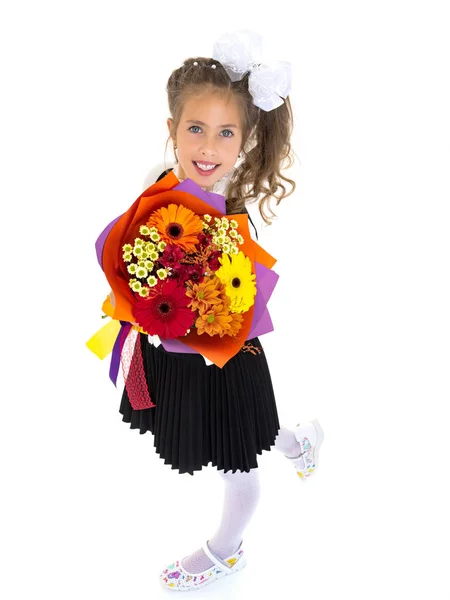 Little girl goes to school with a bouquet of flowers. — Stock Photo, Image