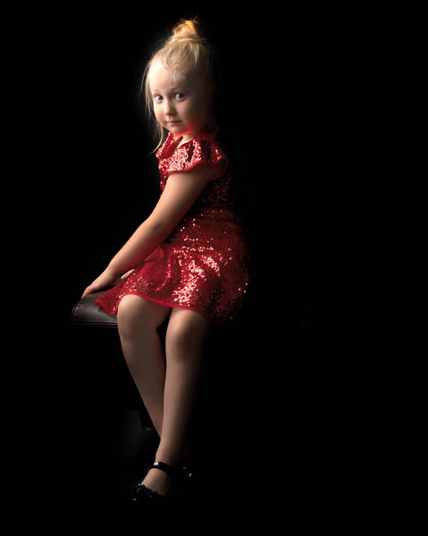 Little girl on a black background