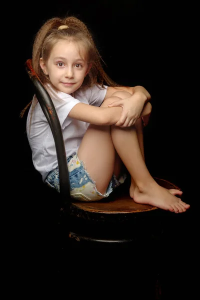 Little girl on a black background — Stock Photo, Image