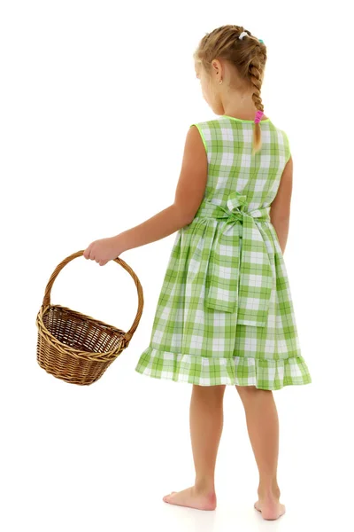 Little girl with a wicker basket — Stock Photo, Image