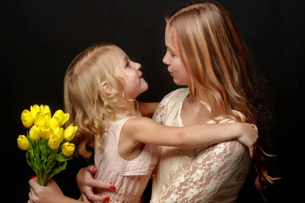 Dvě malé dívky s květinami. — Stock fotografie