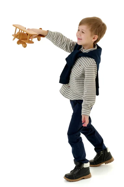 Little boy playing with wooden plane — Stock Photo, Image