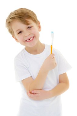 Küçük bir çocuk diş fırçasıyla dişlerini fırçalıyor..