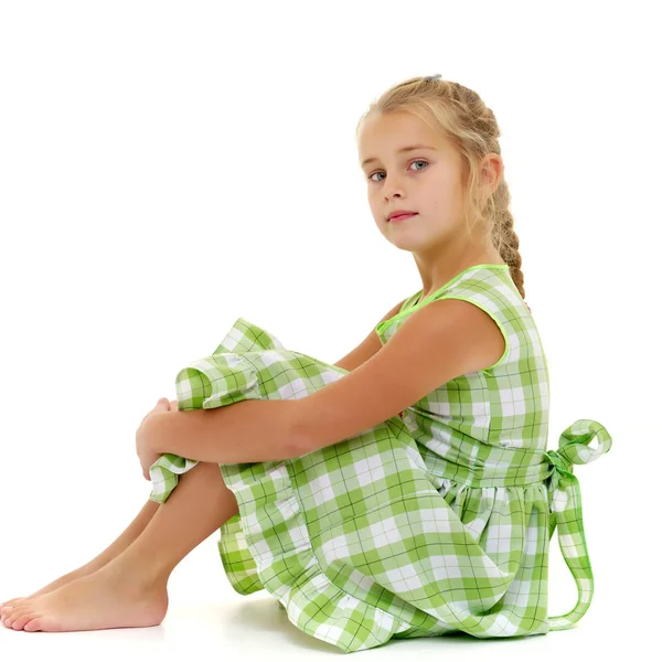 Little girl is sitting on the floor. — Stock Photo, Image