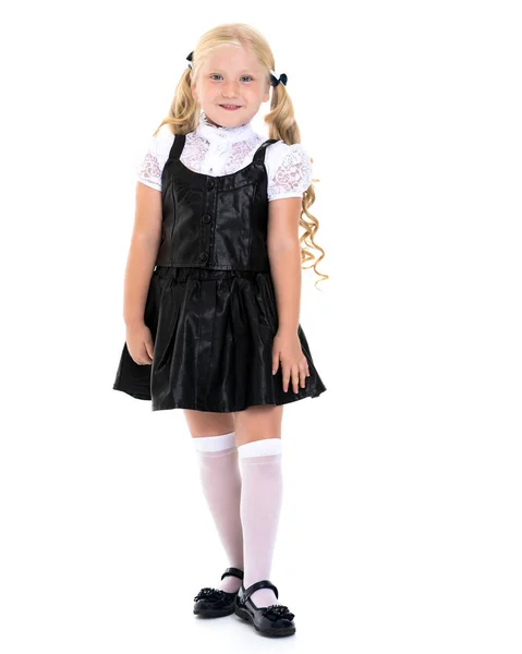 Vacker liten flicka i en skoluniform. — Stockfoto