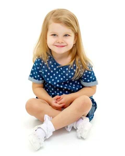 Little girl is sitting on the floor. — Stock Photo, Image