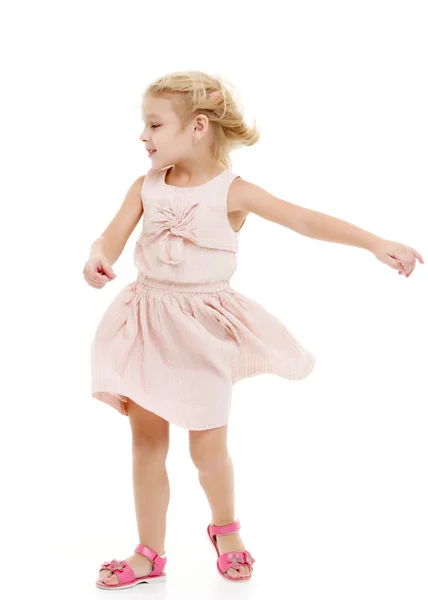 Little girl in a dress developing in the wind. — Stock Photo, Image