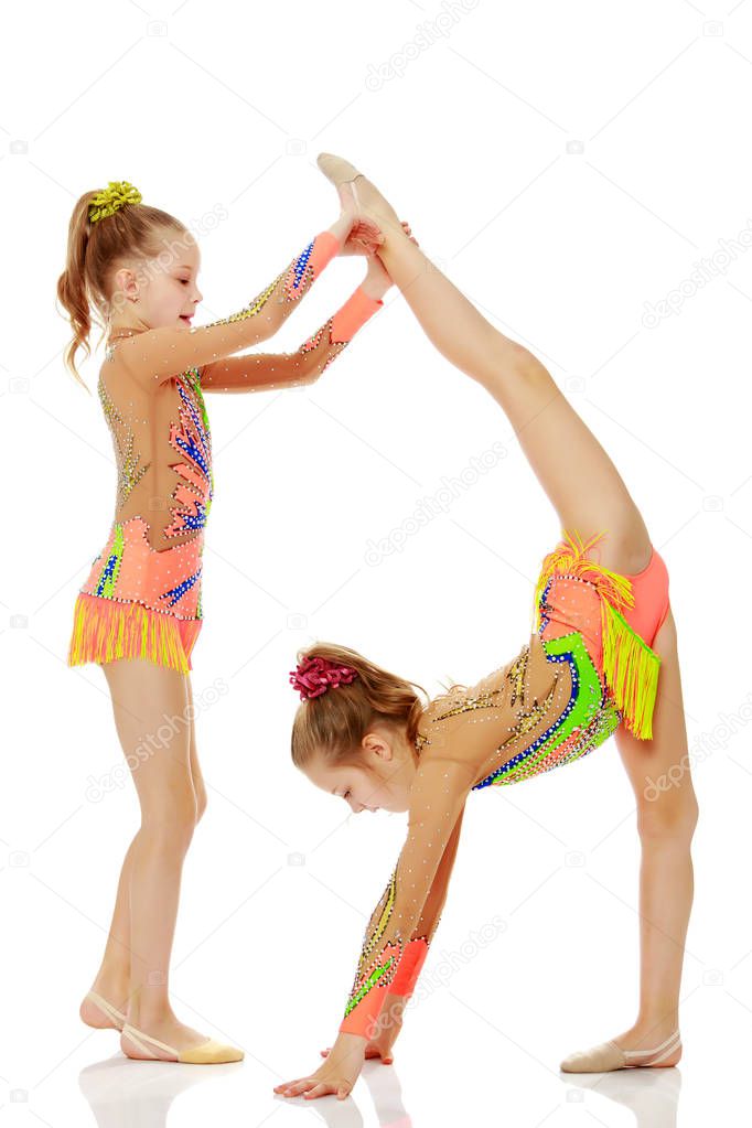 Girls gymnasts perform exercises.