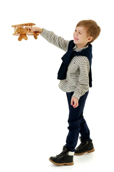 Little boy playing with wooden plane — Stock Photo, Image