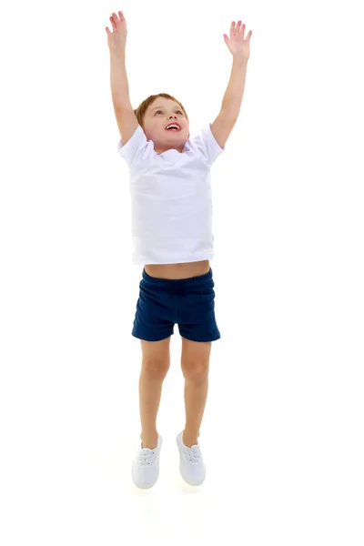 Un niño pequeño con una camiseta blanca limpia está saltando divertido . — Foto de Stock