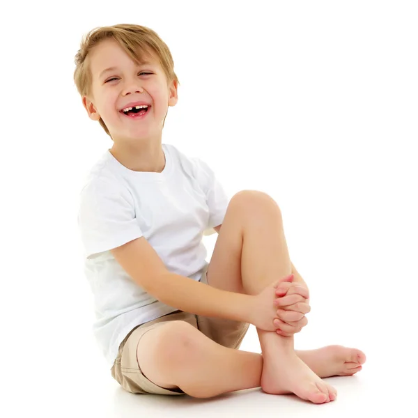 A little boy in a pure white t-shirt laughs. Emotions. — Stock Photo, Image