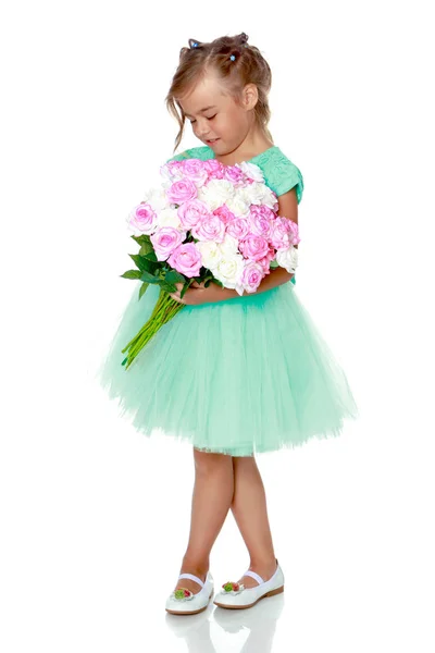 Little girl with a bouquet of flowers — Stock Photo, Image