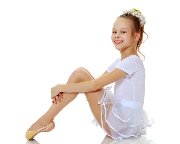 Little girl hugging her knees. — Stock Photo, Image