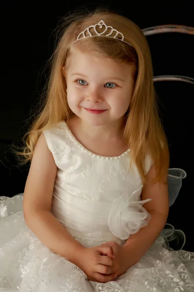 Little girl on a black background Stock Picture
