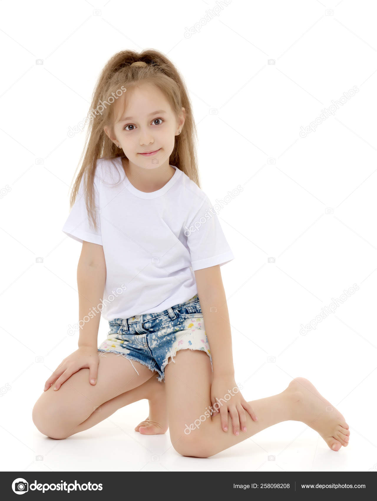 Charming girl in a pure white t-shirt for advertising and shorts