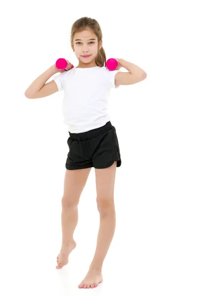 Teenage girl with dumbbells in hands — Stock Photo, Image