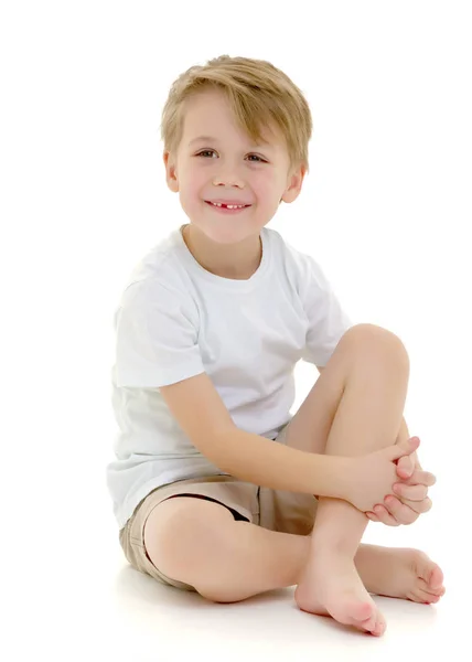 A little boy in a pure white t-shirt laughs. Emotions. — Stock Photo, Image