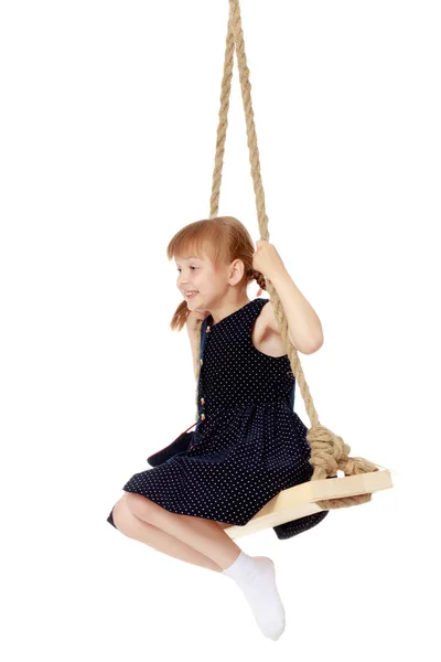 Little girl swinging on a swing — Stock Photo, Image